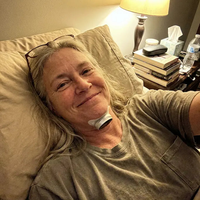 A real customer resting comfortably in bed wearing Haldrow Pro