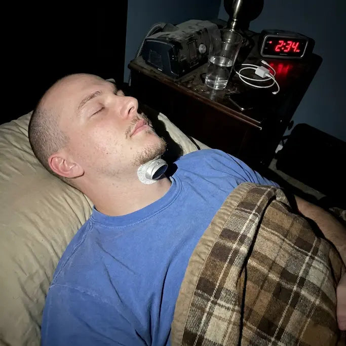A man sleeping quietly at night wearing Haldrow Pro under his chin
