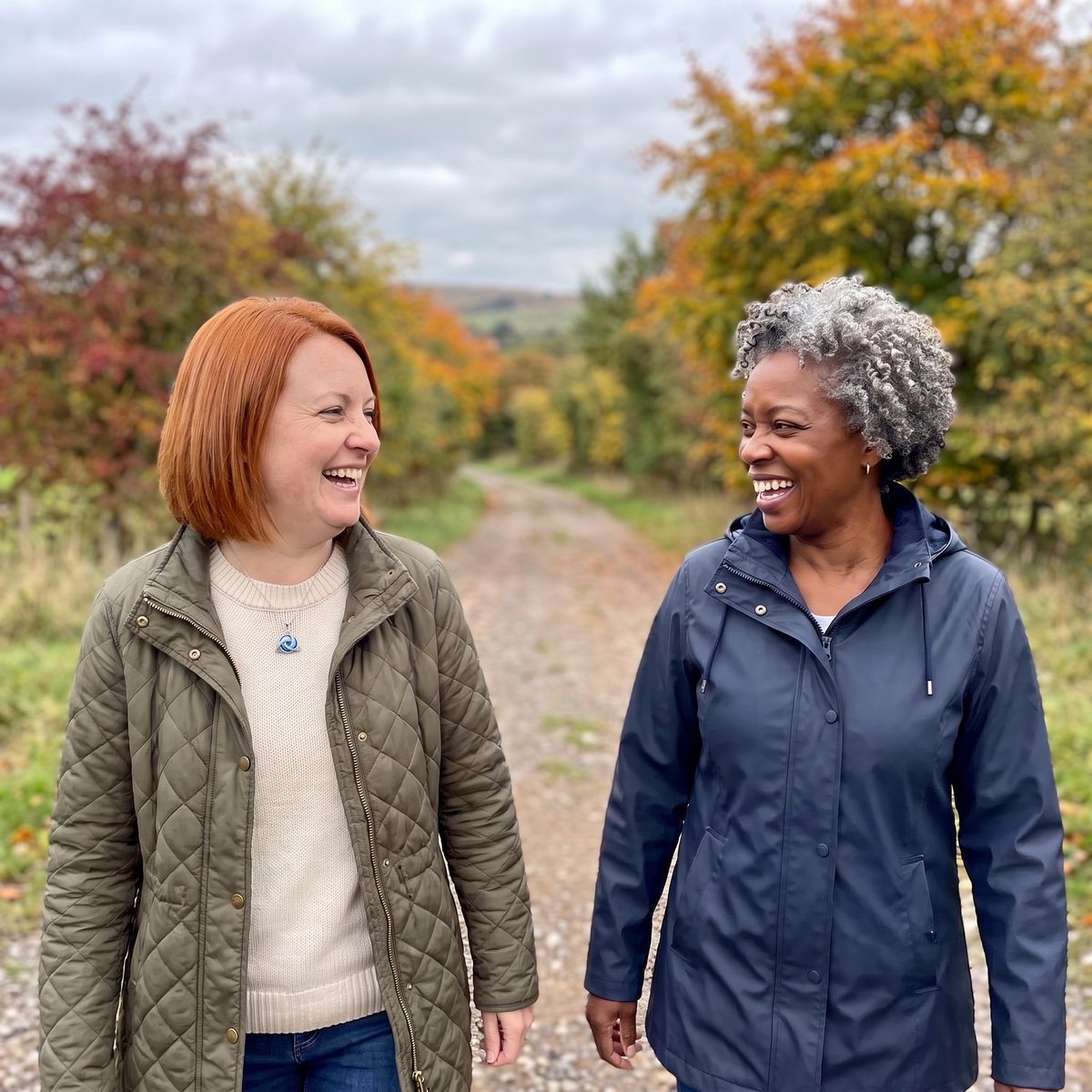 Two friends laughing on a fall walk